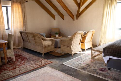 a living room with chairs and a table at Cosy Farmhouse Studio On Springrove in Nottingham Road