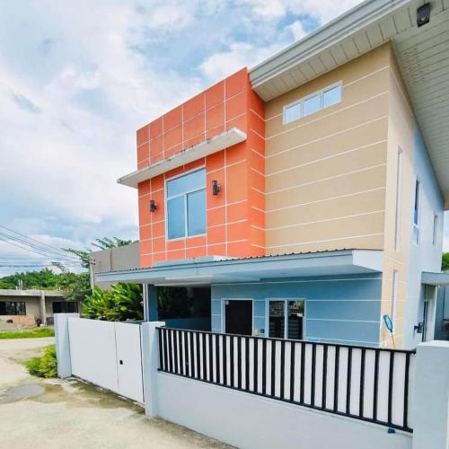a house with an orange and blue at Ada's Residential Villa La Union in Agoo