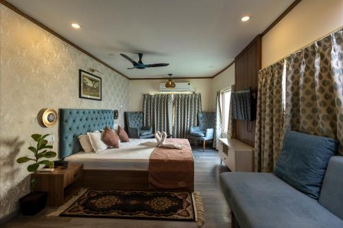 a bedroom with a bed and a couch at Vikash Eco Resort in Bālugān