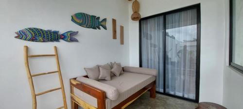 a room with a couch and a ladder and a window at Villa Francine El Nido in El Nido