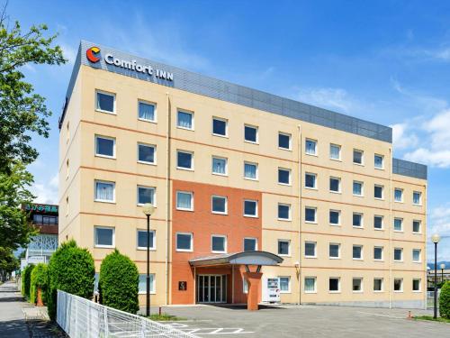 a building with a sign on the top of it at Comfort Inn Fukushima Nishi Inter in Fukushima