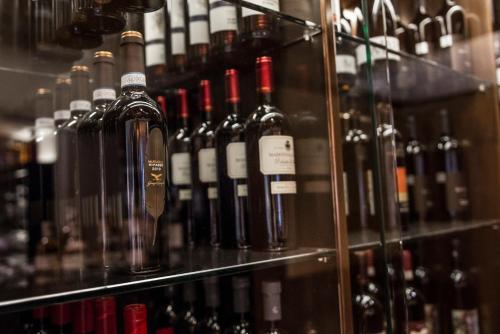 a bunch of wine bottles on display in a store at Hotel Villa Kastelruth in Castelrotto