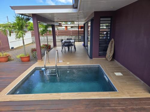 a swimming pool in the middle of a house at Fare Kenzo 2 in Papara