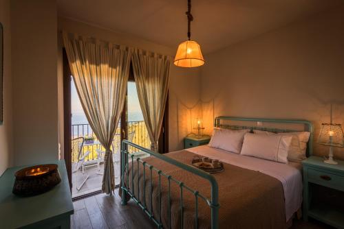 a bedroom with a bed and a balcony at Yades Villas in Athanion