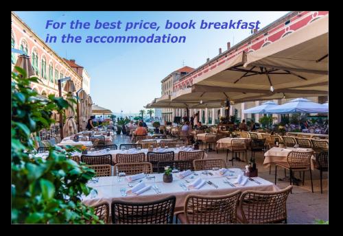 an outdoor restaurant with tables and chairs and a sign that reads for the best price at Priska Heritage Rooms in Split