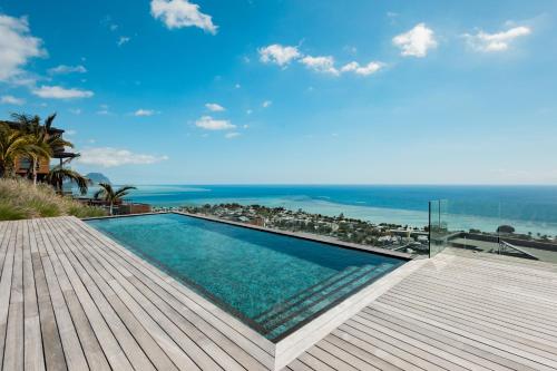a swimming pool with a view of the ocean at Legend Hill Resort and Spa in Rivière Noire