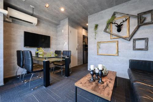 a living room with a table and a couch at RAKU Hotel Tokyo Bay Front in Tokyo