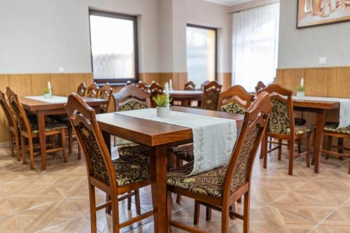 a dining room with wooden tables and chairs at Penzión Alpský dom in Vitanová