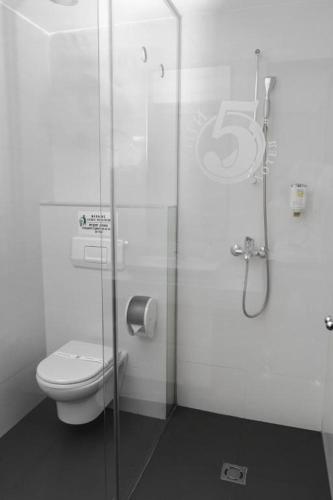 a bathroom with a toilet and a glass shower at Luxury Skopje Apartments in Skopje
