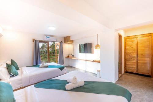 Postel nebo postele na pokoji v ubytování Siargao Lisuga Hotel