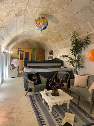 a living room with a bed and chairs and a table at la cave in Montoire-sur-le-Loir