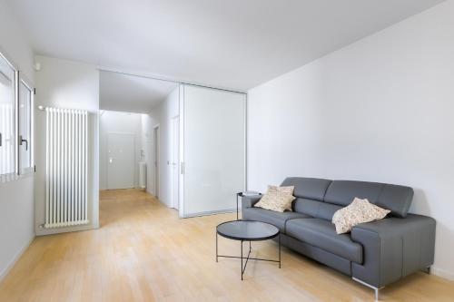a living room with a couch and a table at Casa Conca in Alba