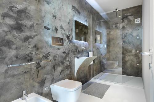 a bathroom with a toilet and a sink at Casa Conca in Alba