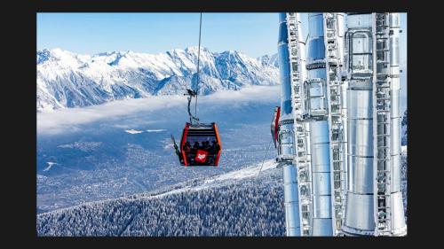 a group of people riding a ski lift on a mountain at Studio Bike & Snow in Innsbruck