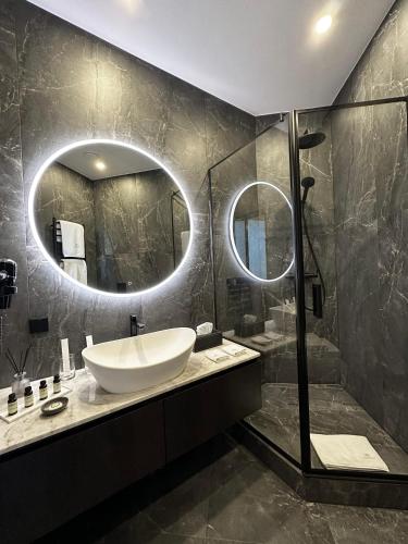 a bathroom with a sink and a large mirror at Boutique Hotel Light House Jurmala in Jūrmala