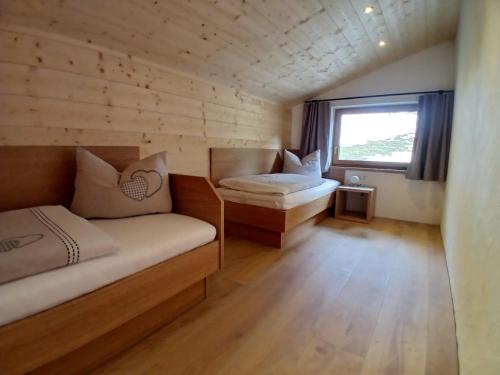 a small room with a couch and a window at Ferienwohnungen Tauernalm in Heiligenblut