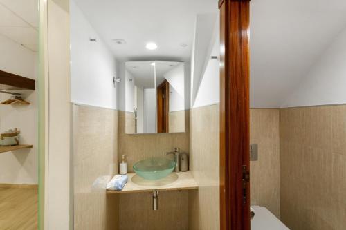 a bathroom with a sink and a mirror at Eva García Naranjo in Las Palmas de Gran Canaria