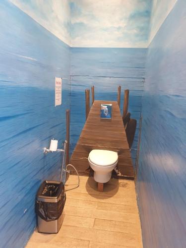 a bathroom with a toilet on a wooden pier at Nusa dua Ocean View with Private Beach in Nusa Dua