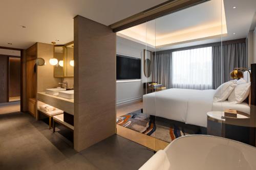 a hotel room with a bed and a sink at Mövenpick Hotel Jakarta City Centre in Jakarta
