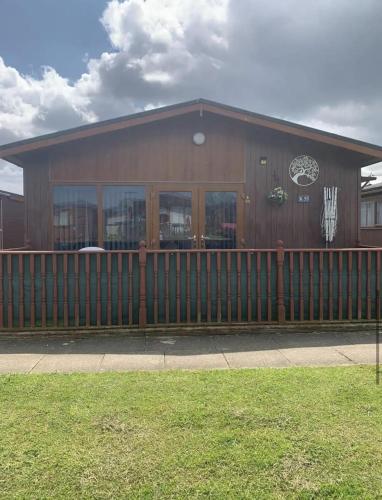 a building with a fence in front of it at 2 Bed Chalet Sleeps 6 - Pets Near Beach Parking in Mablethorpe