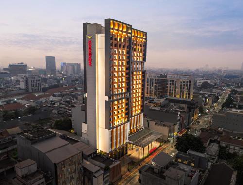 a rendering of a tall building in a city at Mövenpick Hotel Jakarta City Centre in Jakarta