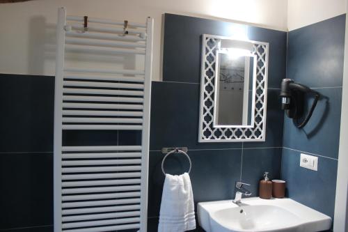 a bathroom with a sink and a mirror at Colle Rooms HELIANTHUS in Santa Maria degli Angeli