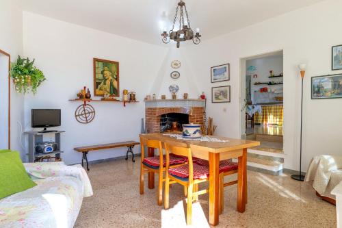 a living room with a table and a fireplace at Trullo Nunuccio in Ceglie Messapica