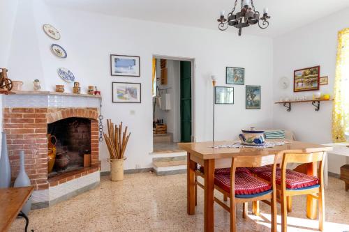 a living room with a table and a fireplace at Trullo Nunuccio in Ceglie Messapica