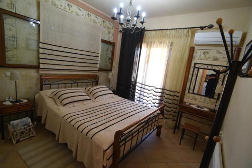 a bedroom with a large bed and a mirror at Villa Erato in Kineta