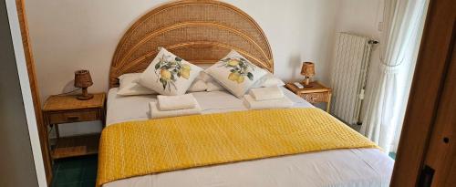 a bedroom with a large bed with a wooden headboard at Limonero suite in Vico Equense