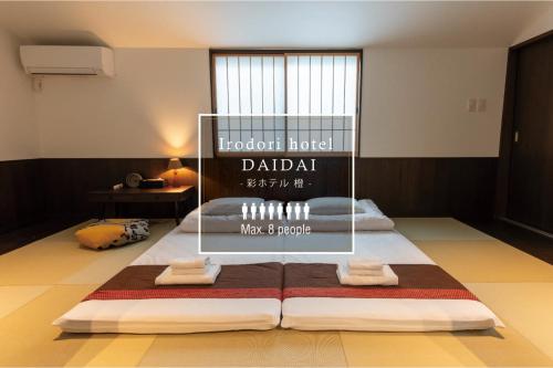 a room with a bed with towels on it at Irodori Hotel DAIDAI in Fukuoka