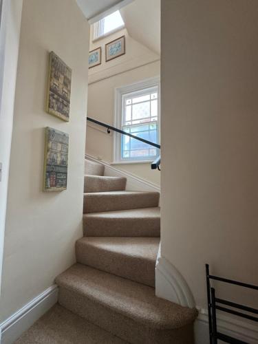 a staircase in a house with a window at The Staff Quarters in Shifnal