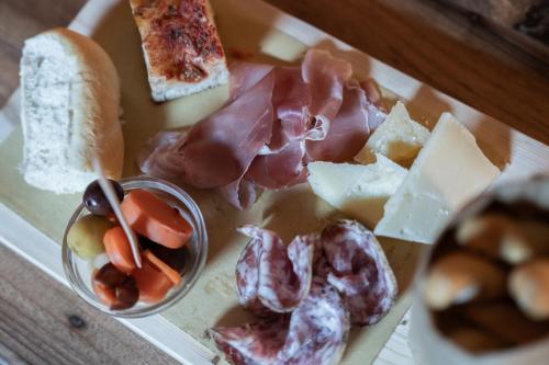 a tray of different types of meats and cheese at VerdeOlivo 1876 - Apartments & Pool in Mezzane di Sotto