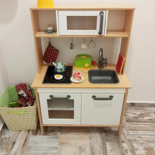 a small kitchen with a sink and a microwave at Familly Apartmens in Dolní Dunajovice