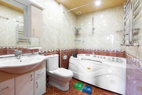 a bathroom with a toilet and a sink and a tub at Leyla Apartments 1 in Baku