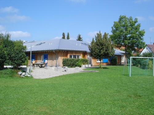 a house with a soccer field in the yard at Jugendherberge Ottobeuren - membership required in Ottobeuren
