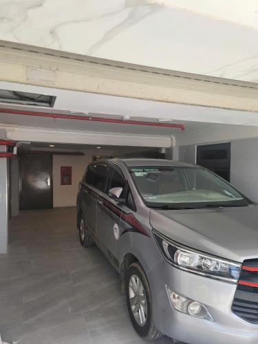 a silver car parked in a parking garage at Nature Hotel - Nam Ky Khoi Nghia in Da Lat