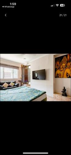 a bedroom with a bed and a couch in a room at Parigold in New Delhi