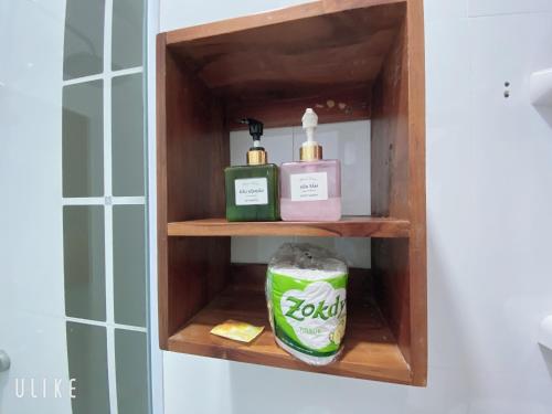 a bathroom shelf with two bottles of soap and a can at Elephant Boutique Hotel in Luang Prabang