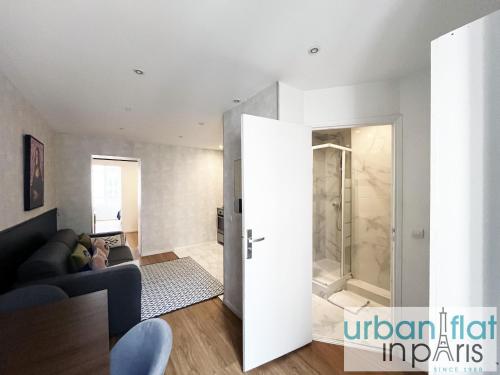 - un salon avec une porte en verre menant à une douche dans l'établissement Urban Flat 04 - Pretty 2 Bedroom Flat in Montorgueil, à Paris