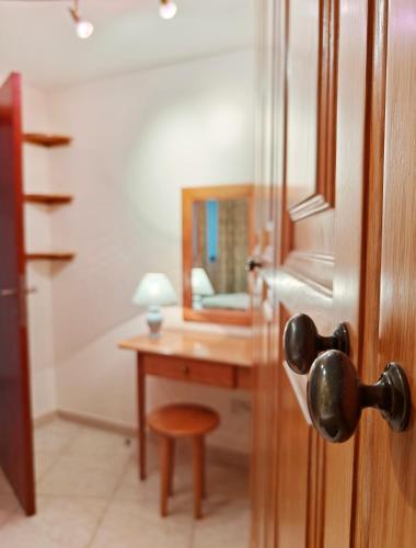 a bathroom with a wooden door with a desk and a mirror at Portomaso seaview in Sliema