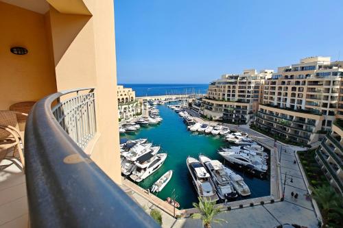a balcony with a view of a marina with boats at Portomaso seaview in Sliema