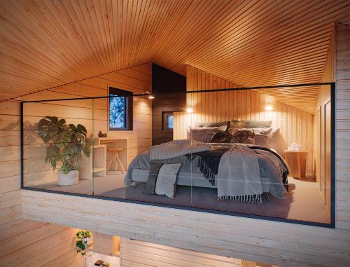 Un dormitorio con una cama en una caja de cristal. en Sunday Morning Resort, en Pyhätunturi