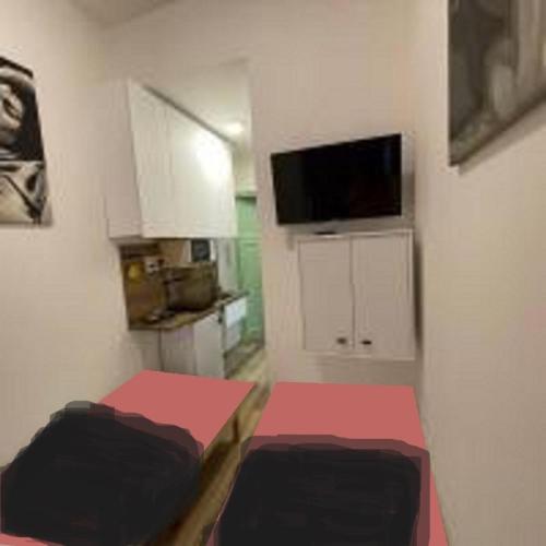 a small room with two beds and a tv at MINATO Apartments Ostrava center in Ostrava