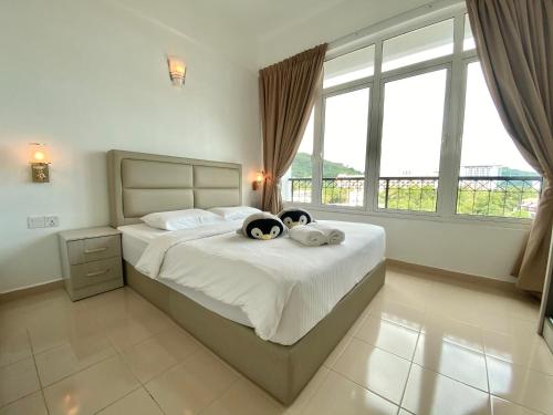 a bedroom with a bed with two towels on it at Century Suria Aparment Langkawi by Zervin in Kuah