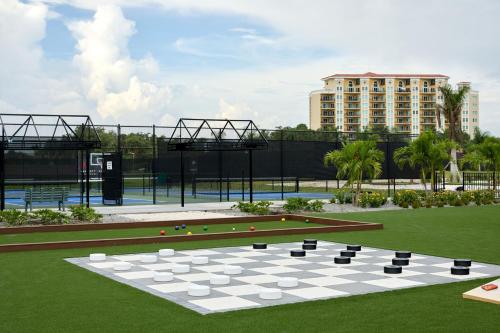 a chess board in a park with a building at Palmetto Marriott Resort & Spa in Palmetto
