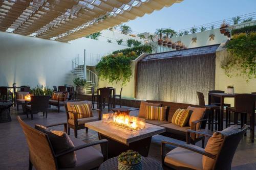 a patio with couches and tables and chairs at The Westin South Coast Plaza, Costa Mesa in Costa Mesa
