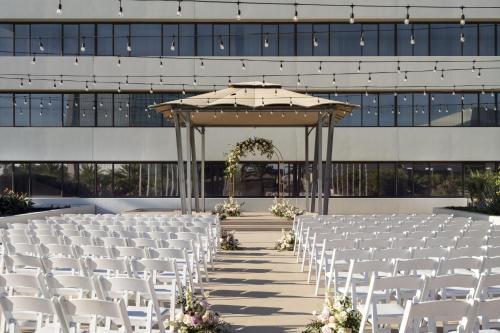 a set up for a wedding ceremony in front of a building at The Westin South Coast Plaza, Costa Mesa in Costa Mesa