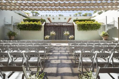 a set up for a wedding ceremony with white chairs at The Westin South Coast Plaza, Costa Mesa in Costa Mesa
