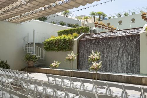a set up for a wedding ceremony with white chairs at The Westin South Coast Plaza, Costa Mesa in Costa Mesa